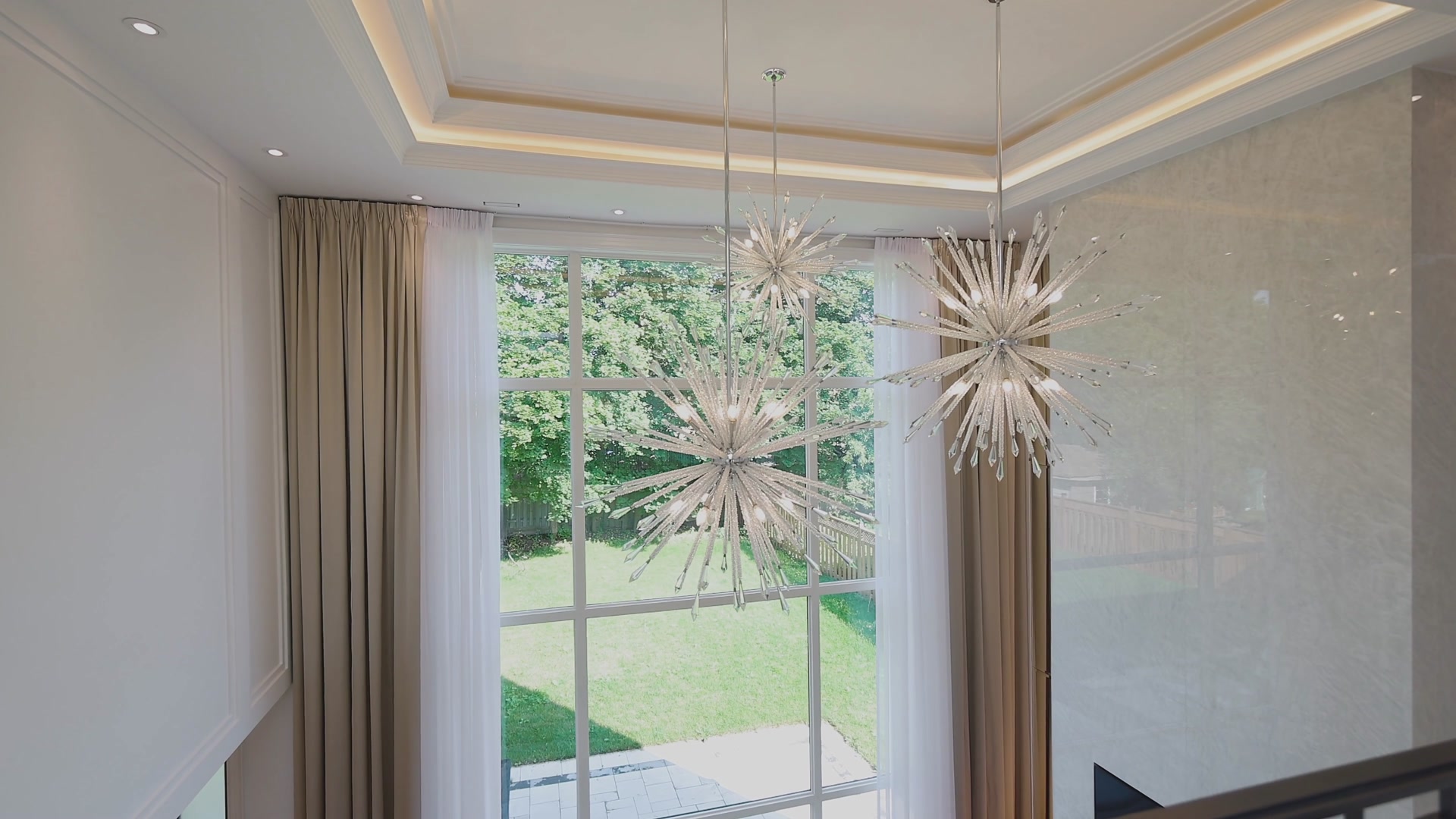 Crystal starburst chandelier in the upper hall