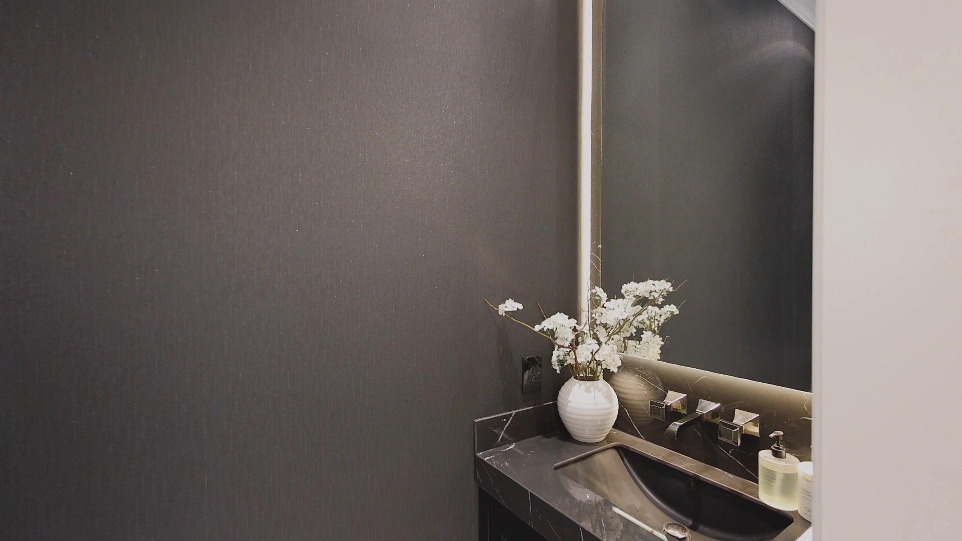 Dark powder room with grasscloth walls