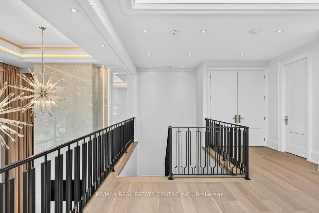 Upper landing with starburst chandelier at 131 Mayfield Drive, Oakville